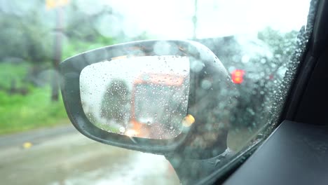 car mirror view on rainy day