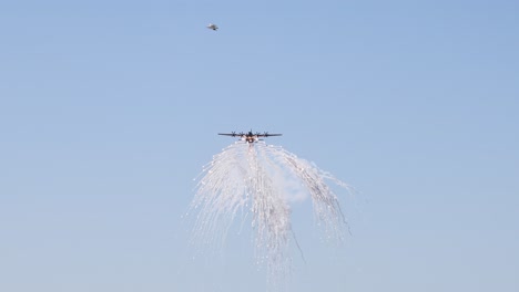 helicopter releases water in a controlled aerial display