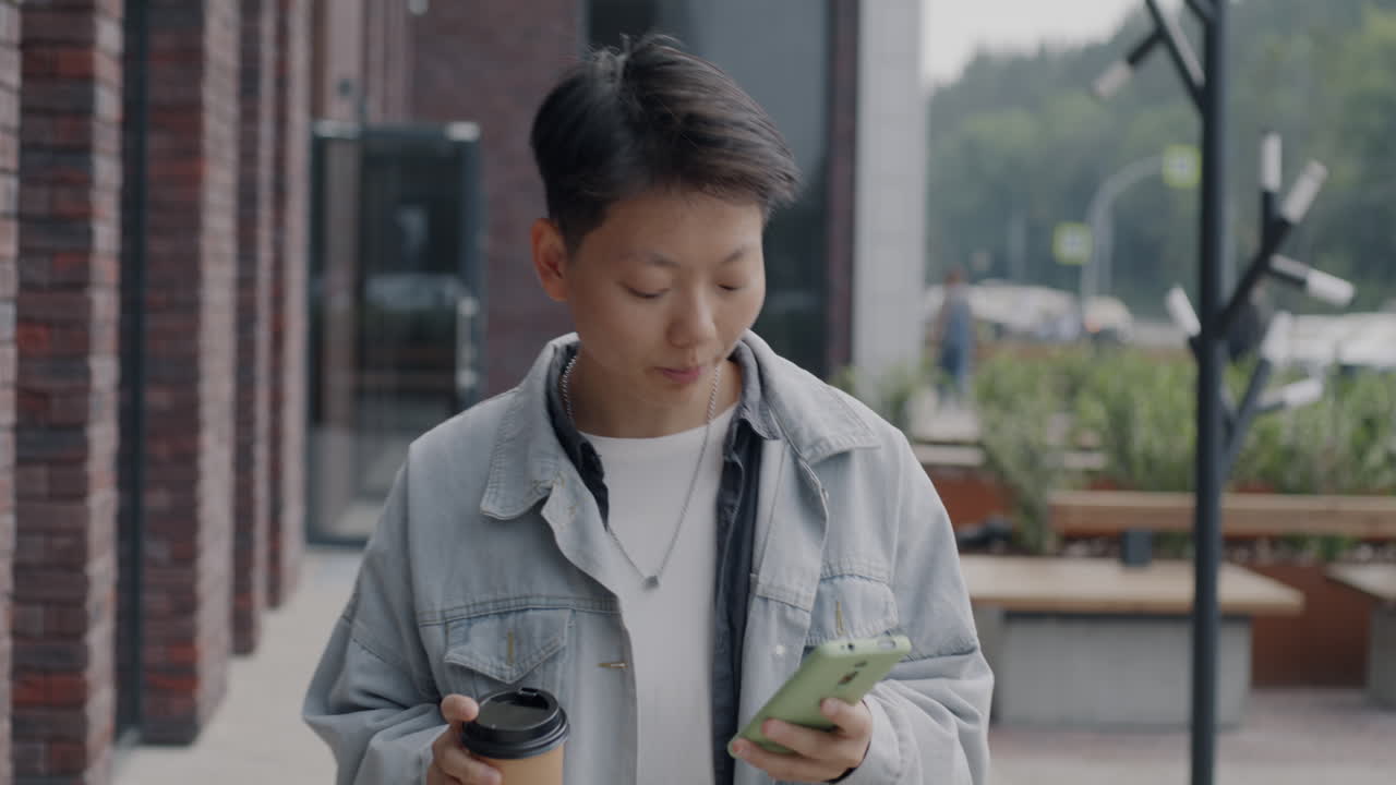 Young Woman Walking and Using Smartphone