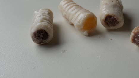 close up and zooming on huesos de santo. traditional spanish marzipan sweet for all saint's day celebration.