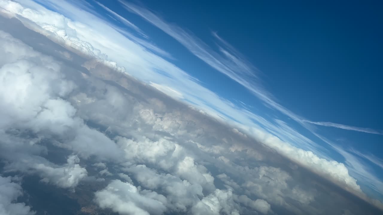 Immersive pilot’s POV FPV flying through a stormy sky doing an abrupt 45 degree left turn over the clouds. Aerial footage taken from a jet cockpit. 4K 60FPS