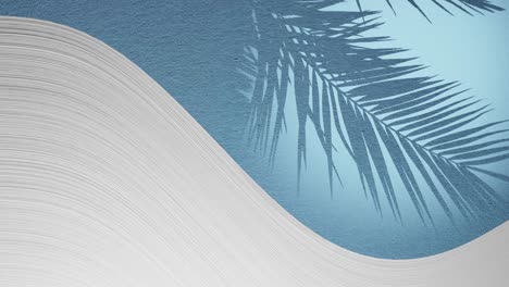 White-plaster-wave-below-light-blue-texture-background-with-palm-frond-shadow