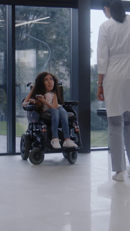 woman in wheelchair consulting with doctor