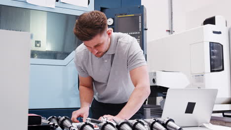 ingeniero masculino midiendo dibujos cad en la fábrica