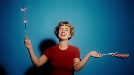 woman celebrating with sparkler and american flag