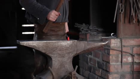 blacksmith working with hammer and anvil