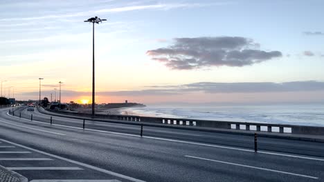 wide shot of scenic car road in portugal, next to a atlantic ocean