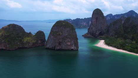 rai leh beach and ao phra nang beach with turquoise waters and limestone cliffs in krabi, thailand. fly reverse drone