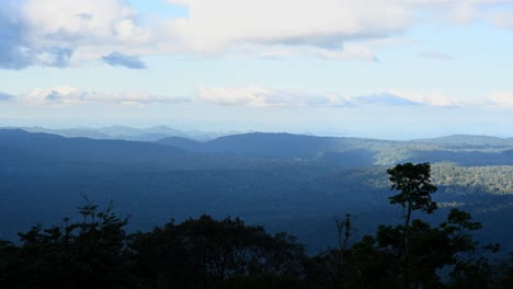 Time-lapse-of-a-lovely-landscape-in-Khao-Khiew-Viewpoint-in-Khao-Yai-National-Park-revealing-rain-clouds-moving-to-the-left-and-the-rainforest-down-below,-Thailand