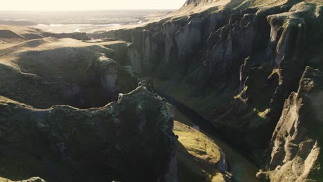 cinematic aerial backward establisher, famous river canyon in iceland, sunrise