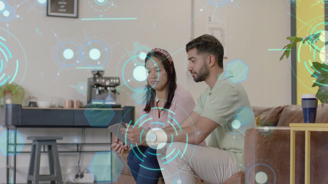 Woman holding tablet listening while man leaning tapping tablet, activating tech demo with teal HUD