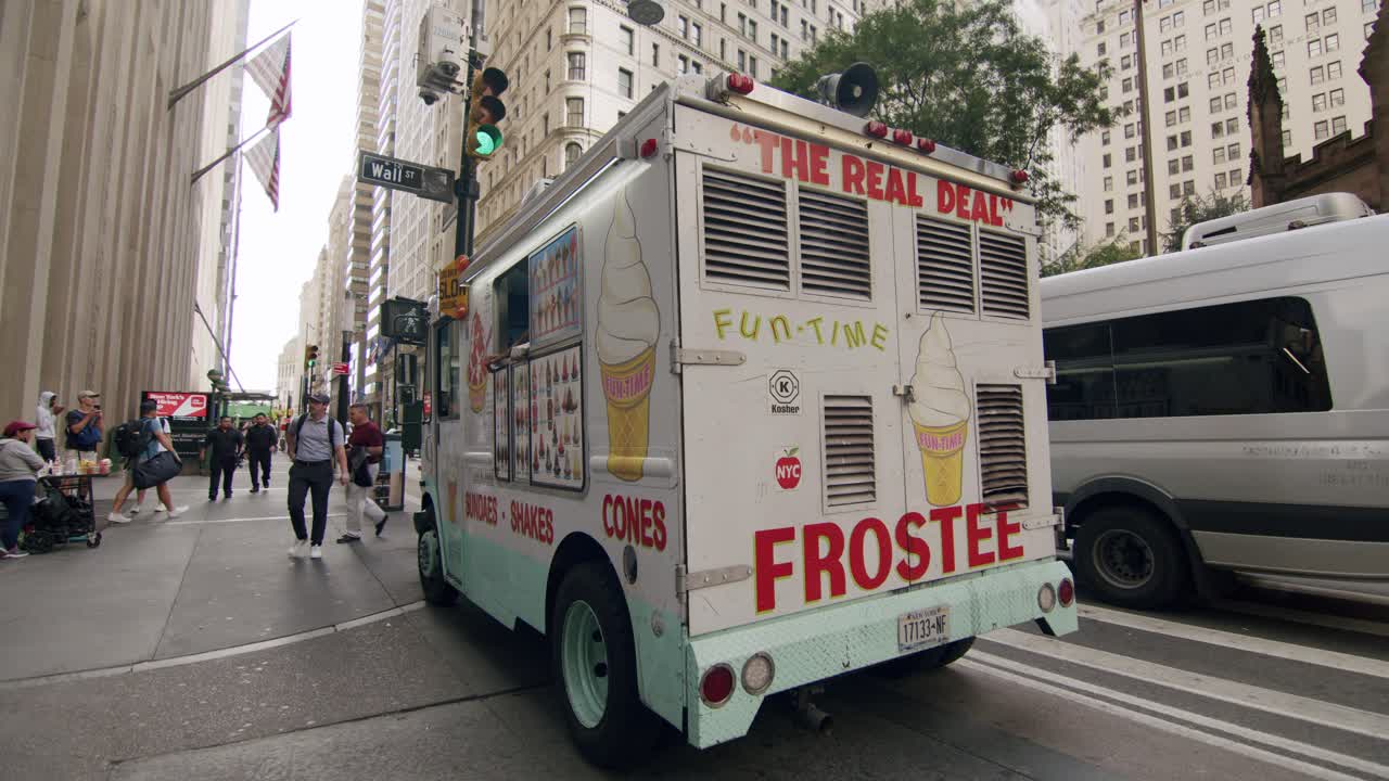 An ice cream truck on a busy street in New York City near Wall Street on a summer day