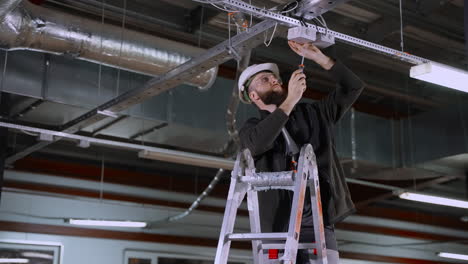 electrician installing ceiling lights