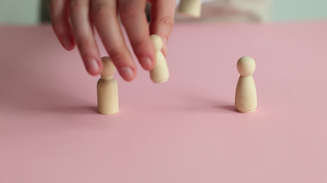 Woman replaces small wooden figures as children at divorce
