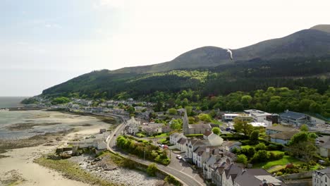 Aerial video of the Mourne Mountains and St John's Church in Newcastle, County Down in Northern Ireland, UK on a bright and sunny day. Filmed in 4K, 60fps and with Rec709 Color.
