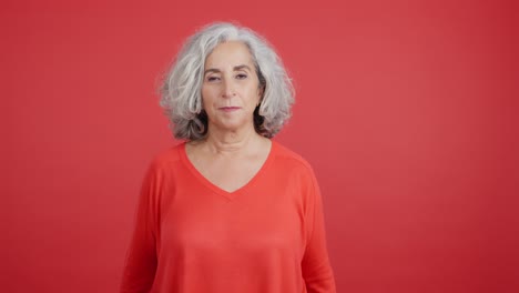 surprised elderly woman in red sweater