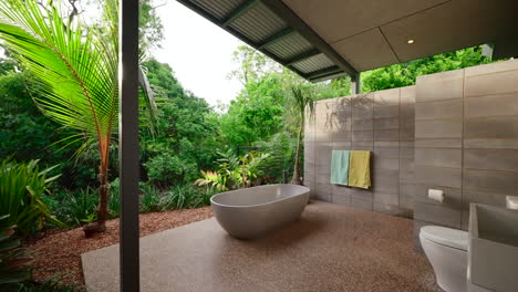 exterior outdoor bath and bathroom nestled within a tropical garden amongst a luxurious large home