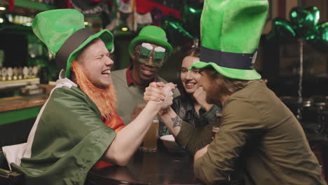 men arm wrestling for fun in pub