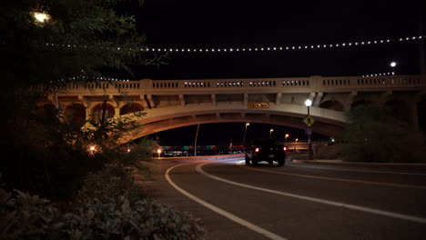 night bridge of road with car driving by