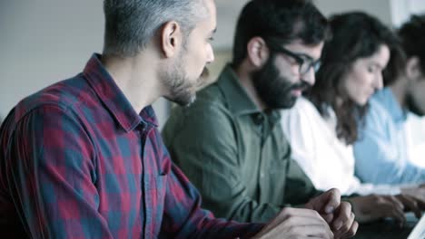 side view of concentrated developers working with laptops