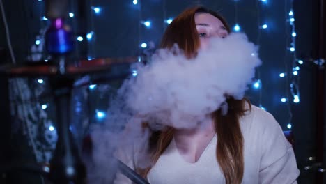 woman smoking hookah in a lounge