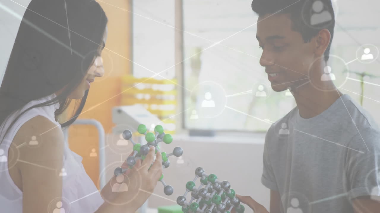 Two people examining molecular models with network connections animation overlay