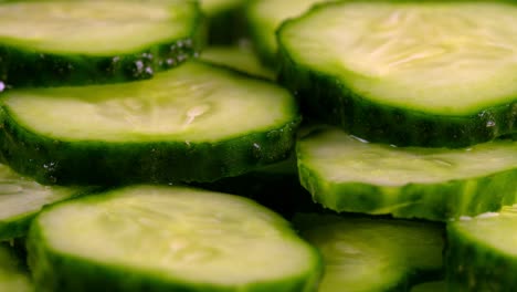 close-up view of rotating sliced green cucumbers.