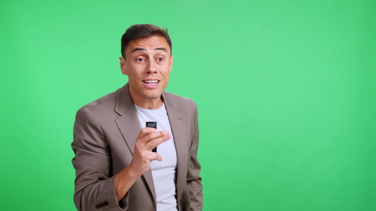 Charismatic male speaker presenting against a green screen background