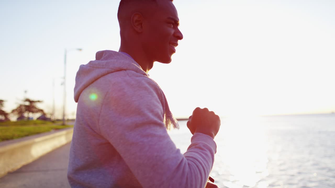 African American male in sun flare exercising outdoors