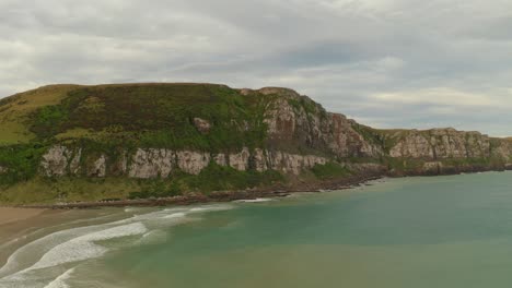 Slow-aerial-sliding-right-to-left-shot-of-cliffs-along-the-coastline-in-New-Zealand