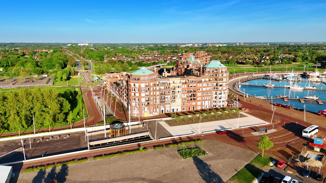 Buildings on the waterfront of lake Markermeer in Lelystad, the Netherlands. Aerial view on port and green scenery of the city.