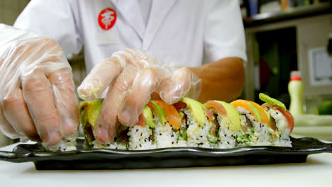 Male-chef-arranging-sushi-in-a-tray-at-kitchen-4k