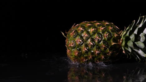 Pineapple-spinning-and-falling-on-wet-black-surface