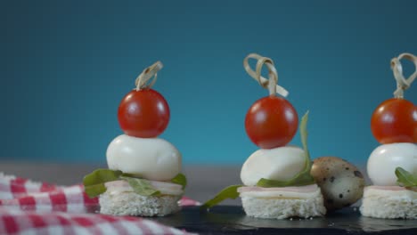 sliding view of poached quail eggs with cherry tomatoes on top.