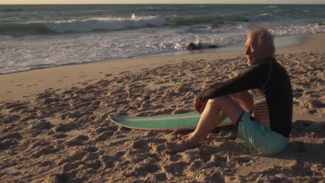 senior man sitting at the beach