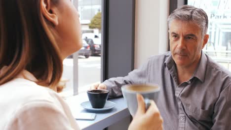 businessman interacting with businesswoman in office cafeteria