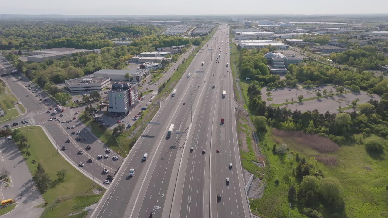 Highway 401 in mississauga with traffic and green surroundings, aerial view