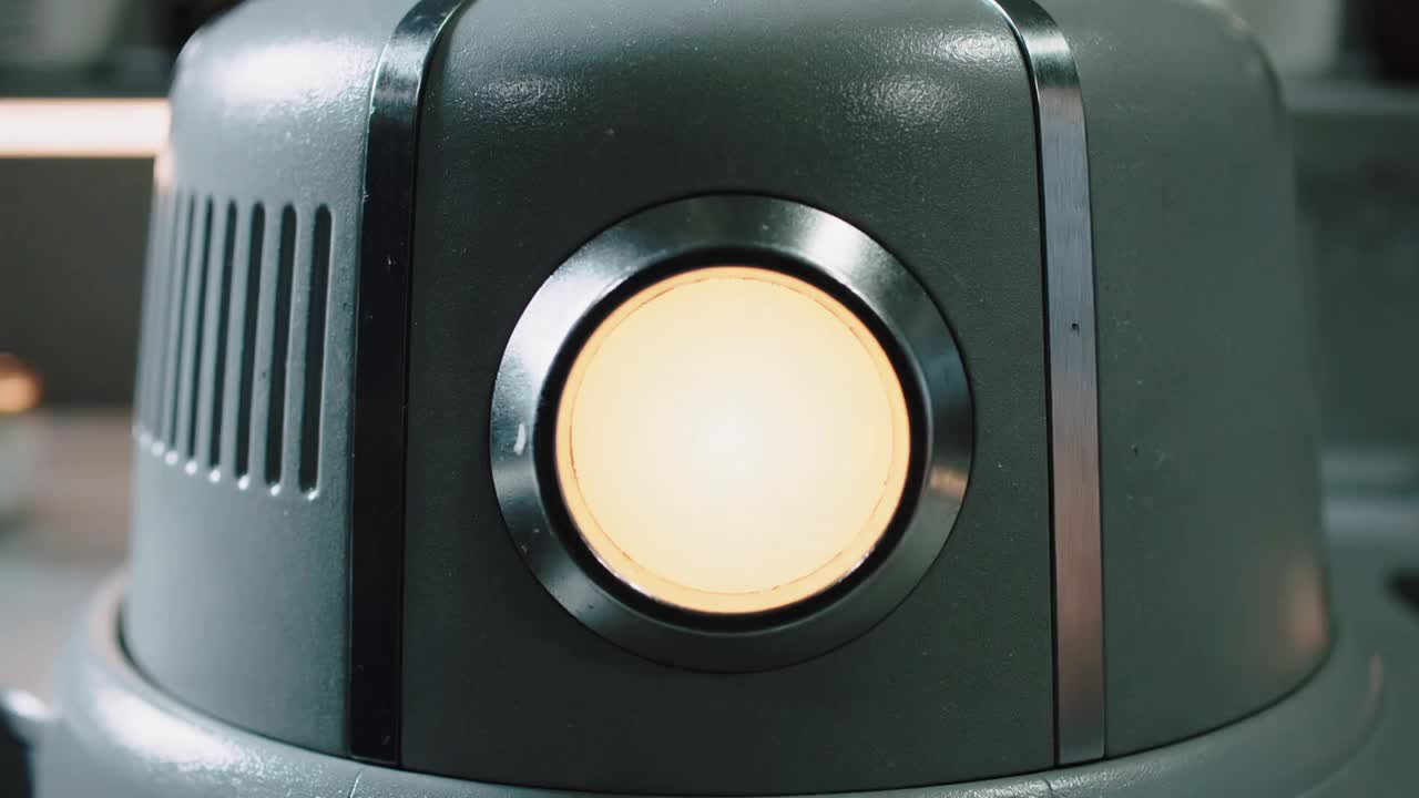 Pressing finger activating lit pad, plating machine building pasta for service on bench, garnishes