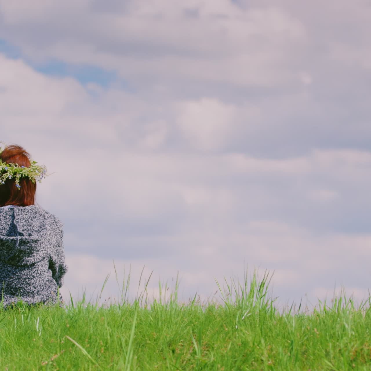 외로운 여자가 푸른 언덕에 앉아 있다