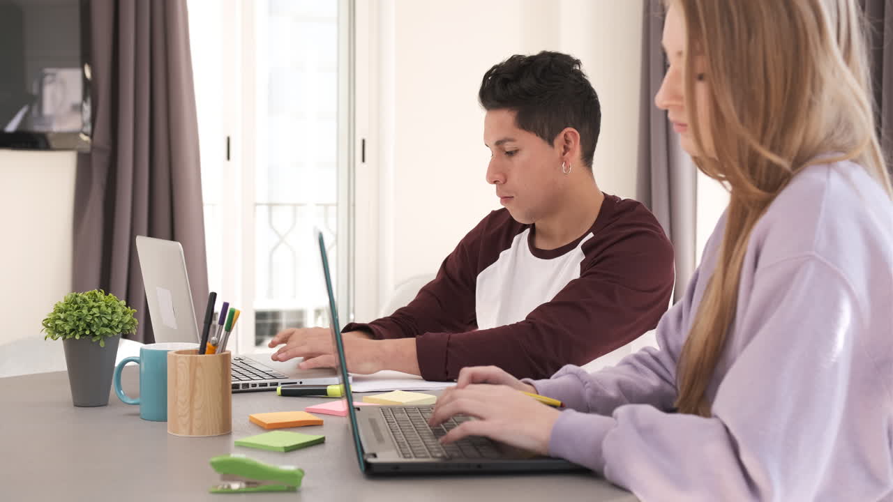 Focused Young freelancer couple sitting at desk working at home. Freelance, home office, remote work, online concept