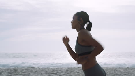 Woman,-running-and-listening-to-music-on-beach