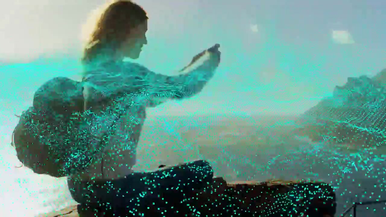 Woman tapping phone on cliff, activating teal particles wrapping torso, framing coastline for tech