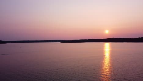 Sunset-in-Stockholm-Archipelago-with-golden-reflections-on-water-and-bird-flying