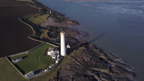 aerial footage of scurdie ness lighthouse in montrose on a sunny day, angus, scotland