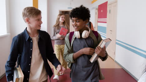 students walking and talking in a school hallway