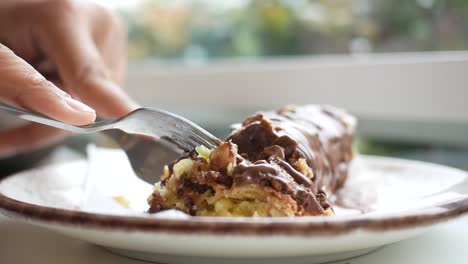 cutting into a chocolate roll cake