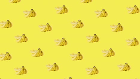 seamless pattern with many bunch of bananas animated in different or diagonal direction on a yellow background. realistic 3d tropical food