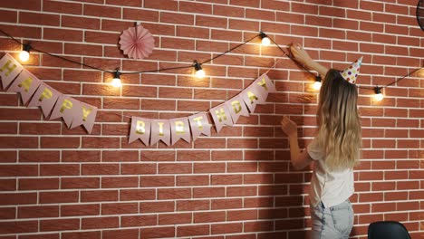 The girl decorates the room for the holiday