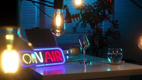 neon 'on air' sign and professional podcast studio setup