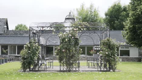 beautiful rose-covered gazebo in a peaceful garden